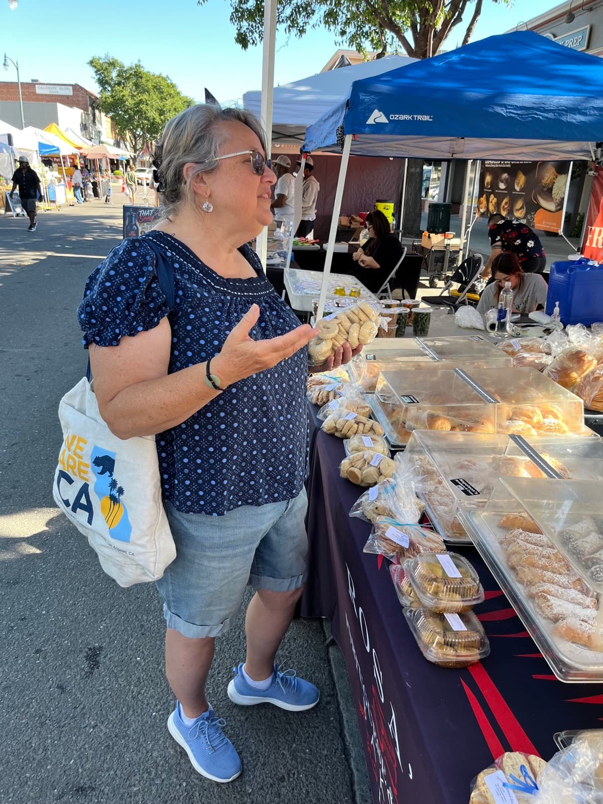 Robin Cole talking with a vendor at a local farmers market